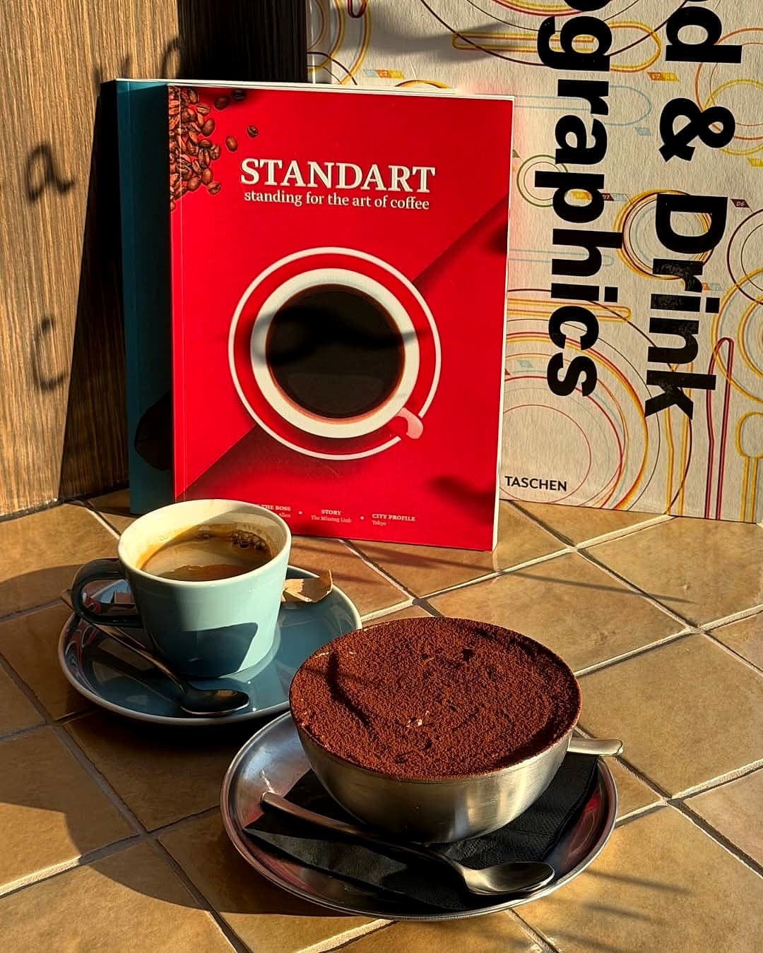 Espresso and homemade tiramisu in morning sun